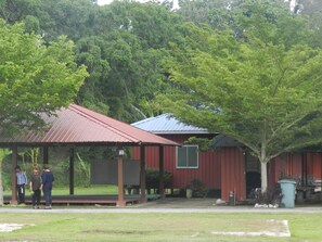 A red building with a covered porch and a metal roof. - The Red Cabanon (Janda Baik)