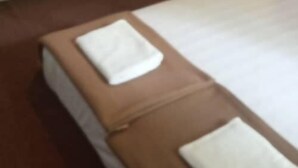 A room with two bunk beds, one with a mattress and pillows on top, and the other with a mattress and a blanket. - The Red Cabanon (Janda Baik)