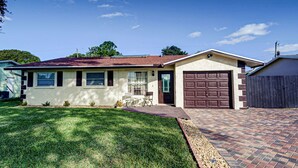 A single-story house with a garage, a front lawn, and a brick driveway. - Home Away From Home   (Boynton Beach)