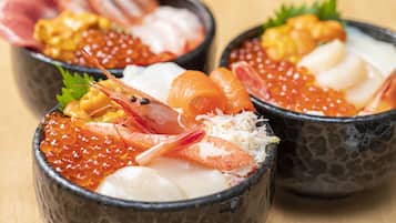 Three bowls of sushi with various toppings.