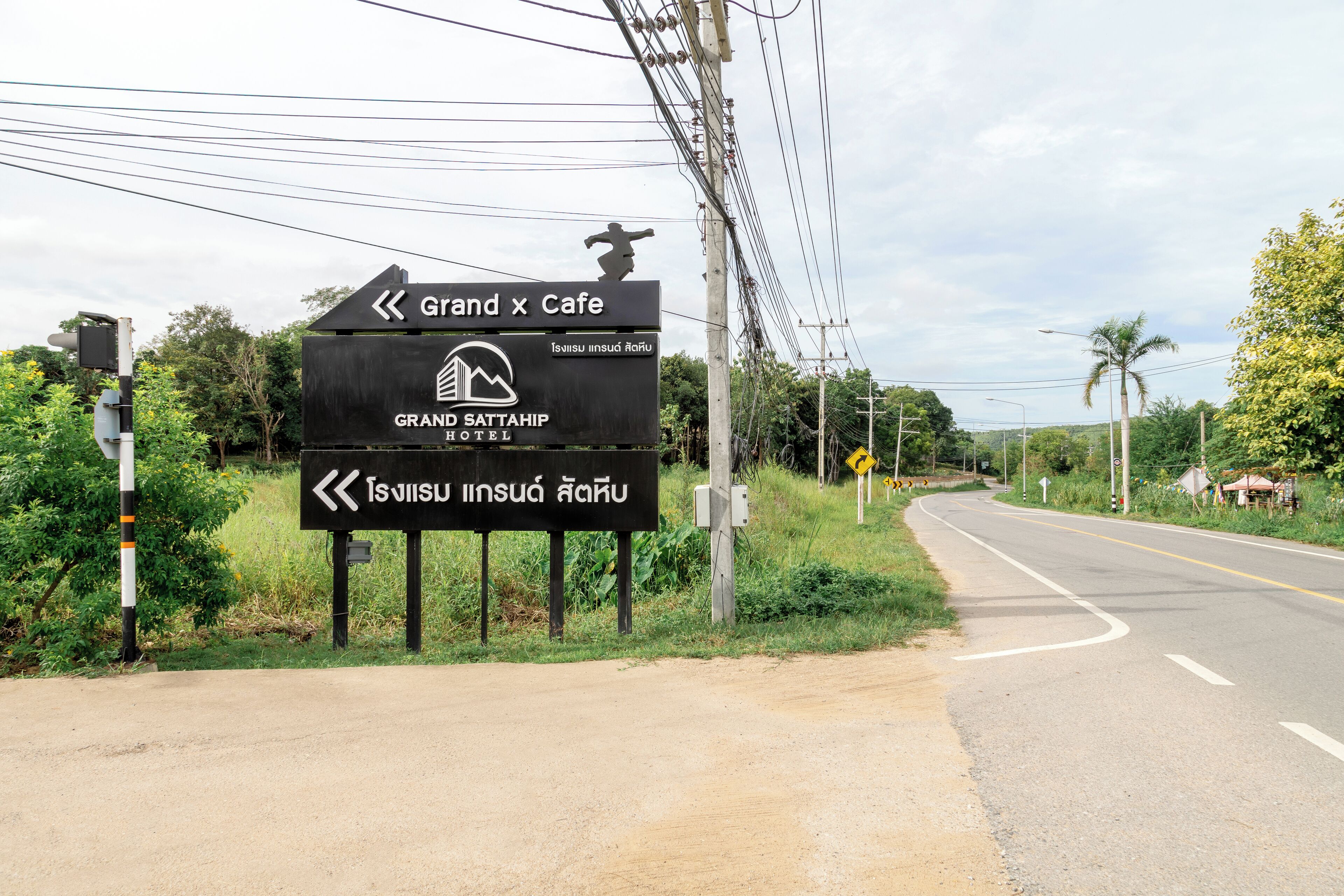 A directional sign for Grand Sattahip Hotel and Grand x Cafe.