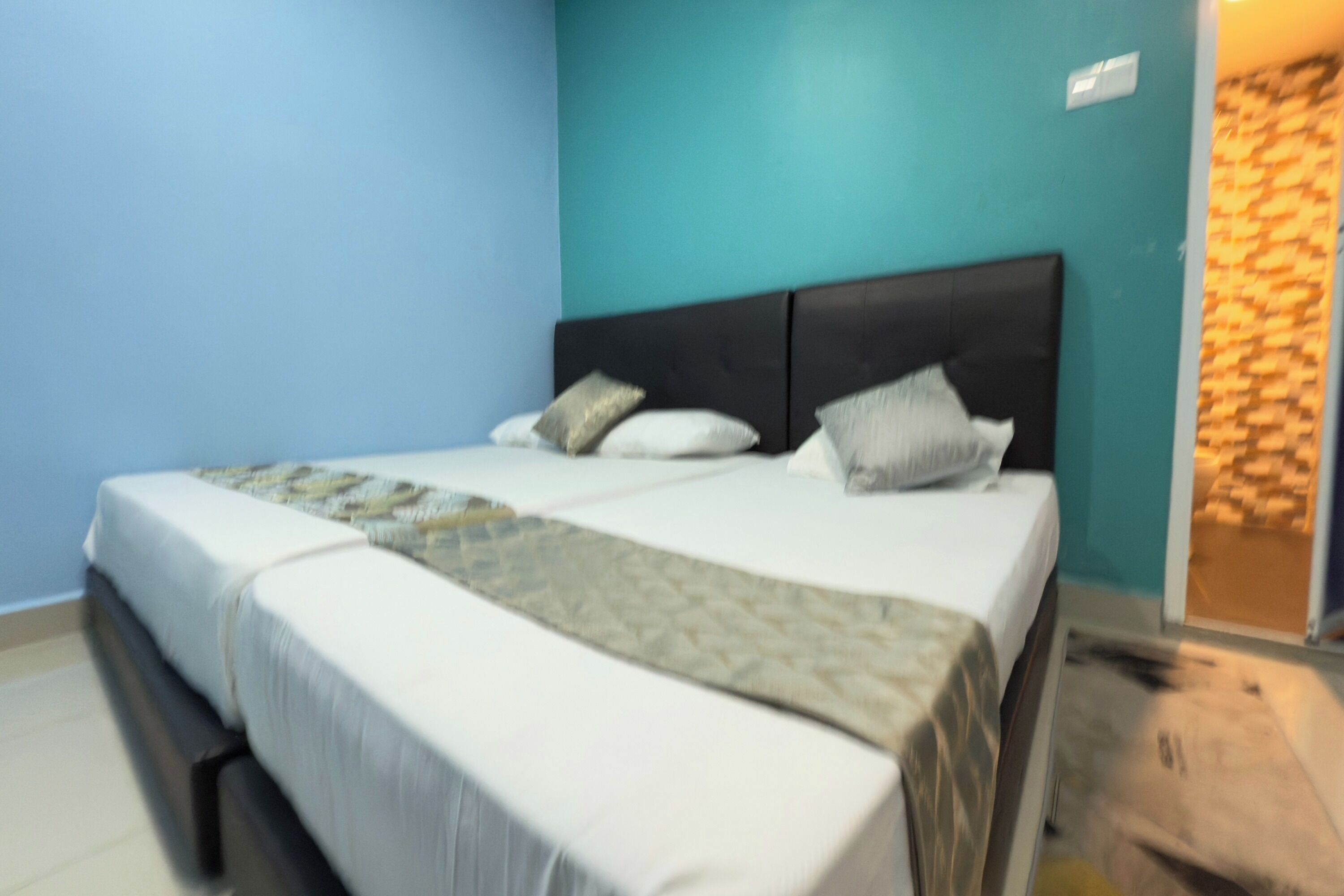 A bedroom with a bed, pillows, and a headboard.