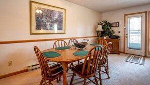 A dining area with a wooden table, chairs, and a ceiling fan. - Deerfield Village 134 - Community Pool, Fire Pit & (Davis)