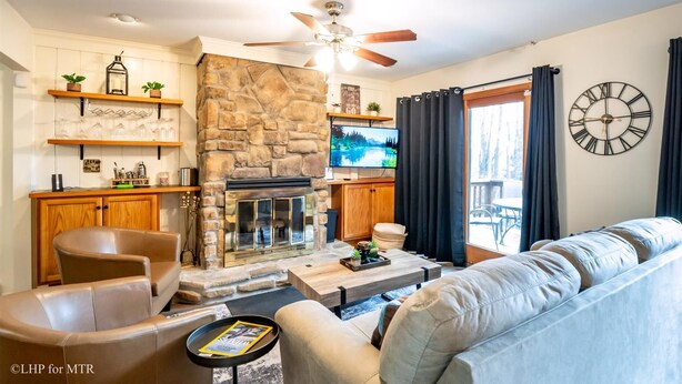 A living room with a stone fireplace, leather sofas, a coffee table, and a TV. - Bear Hug Inn - 74 Lower Lane

Bear Hug Inn - Pet Friendly, Wood Fireplace (Davis)