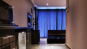 A modern kitchen with a built-in refrigerator, a microwave, and a flat-screen TV. - Green Olive Panorama (Bethlehem)