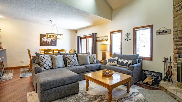 A living room with a sectional sofa, a coffee table, and a fireplace. - Unwind at Quiet Snow - Mountain Retreat w/ Hot Tub (Davis)
