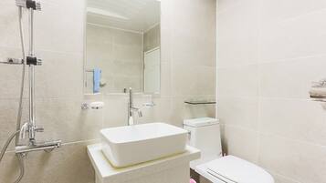 Un bagno moderno con doccia, lavabo e WC.