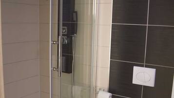 Shower, hair dryer, soap, toilet paper