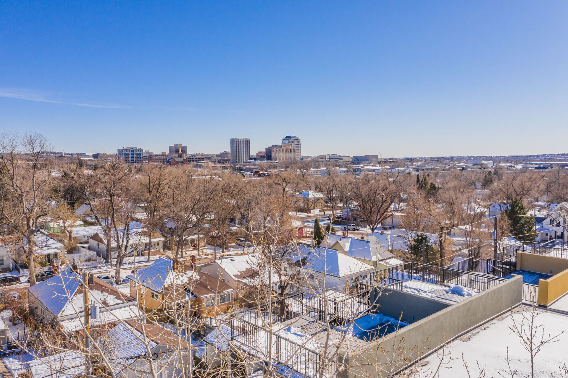 A residential area with houses and a distant city skyline.
