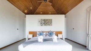 A modern hotel room with a wooden ceiling, a large bed with white bedding, two bedside lamps, and a wall-mounted painting. - 2 Bedroom Sea View Villa Bubbles (Koh Samui)
