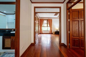 Enter a serene space with a large window and comfortable seating area.