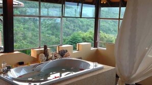 A bathroom with a large bathtub, wooden beams, and a view of lush greenery. - Ever Dreamed of staying in a 2 Bedroom Castle SDV044C - By Samui Dream Villas (Koh Samui)