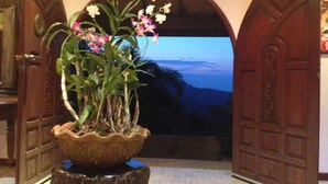 A potted orchid plant on a wooden stump in a doorway. - Ever Dreamed of staying in a 2 Bedroom Castle SDV044C - By Samui Dream Villas (Koh Samui)
