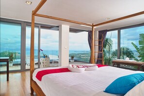 Relax in this serene retreat with a large bed, panoramic views, and access to an outdoor seating area.