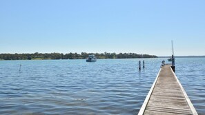 Enjoy a serene lakeside retreat with a pier and tranquil surroundings.