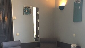 A room with two armchairs, a small table with a coffee maker, and a pet bed. - Carpe Diem (Charleroi)