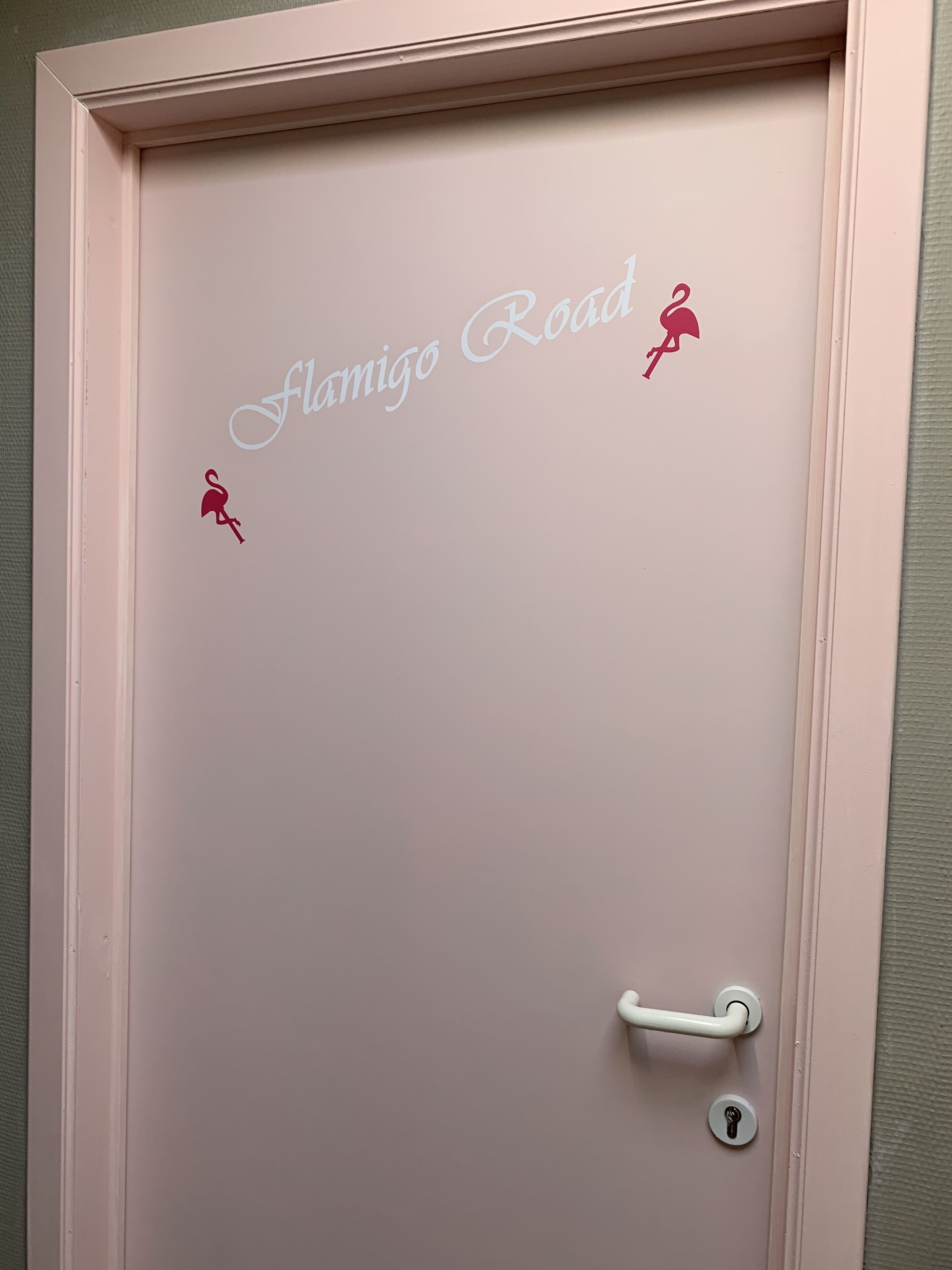 A door with the text "Flamigo Road" and two red figures.