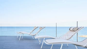 On the beach, sun-loungers, beach umbrellas, beach towels