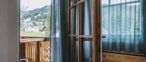 Una terraza de madera con vistas a un paisaje montañoso.