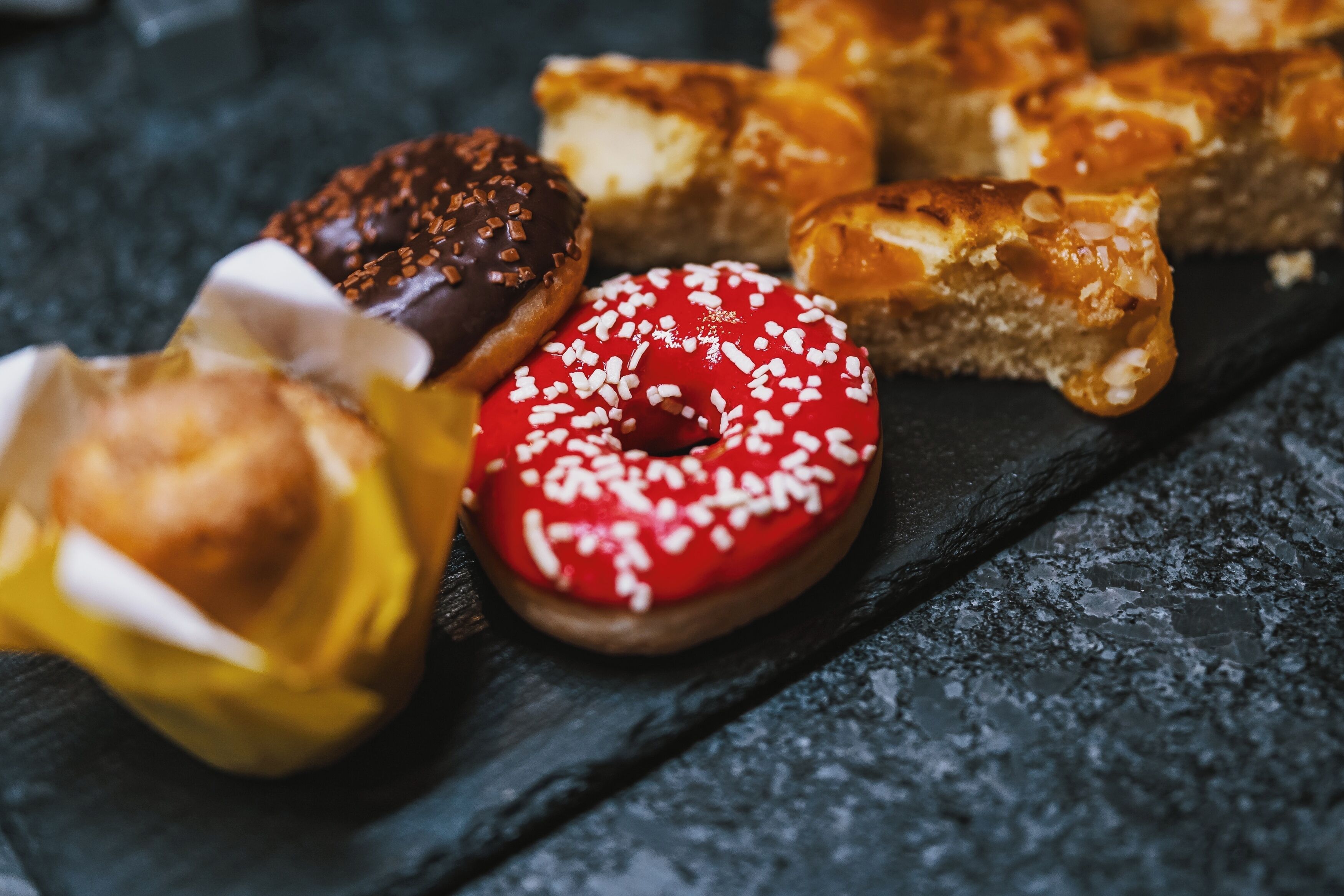 A variety of pastries on a slate surface.