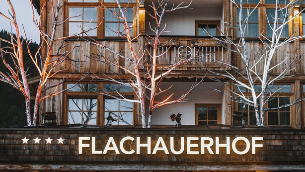 A two-story wooden building with a sign reading "FLACHAUERHOF". - Hotel Flachauerhof  (Flachau)