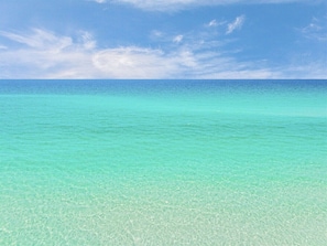 A clear view of a turquoise sea under a blue sky.