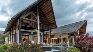 A modern building with a large pool, multiple balconies, and a covered outdoor area. - Villa Bali Il Mare (Gerokgak)