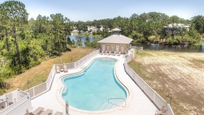 A swimming pool with a deck, lounge chairs, and a small pavilion. - 🐟Lake Views, Bikes-Churchill By The Sea 2308 (Santa Rosa Beach)