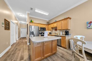 Enjoy cooking in this well-equipped kitchen with a central island and stainless steel appliances.
