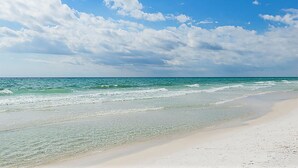 A beach with clear water and a sandy shore under a partly cloudy sky. - ☀️Top Floor-Gulf Views-Pools-30A-Gulf Place Getaway (Santa Rosa Beach)