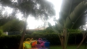 A circular outdoor seating area with colorful chairs. - Reed Hotel Annex (Ongata Rongai)