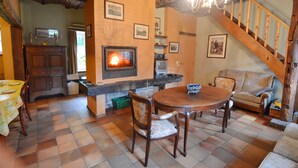 A cozy living room with a fireplace, wooden furniture, and a staircase. - Cozy Cottage in Barvaux-Condroz near Forest (Havelange)