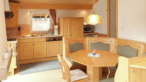 Une cuisine aménagée dans le style d’un chalet en bois, avec un coin repas.