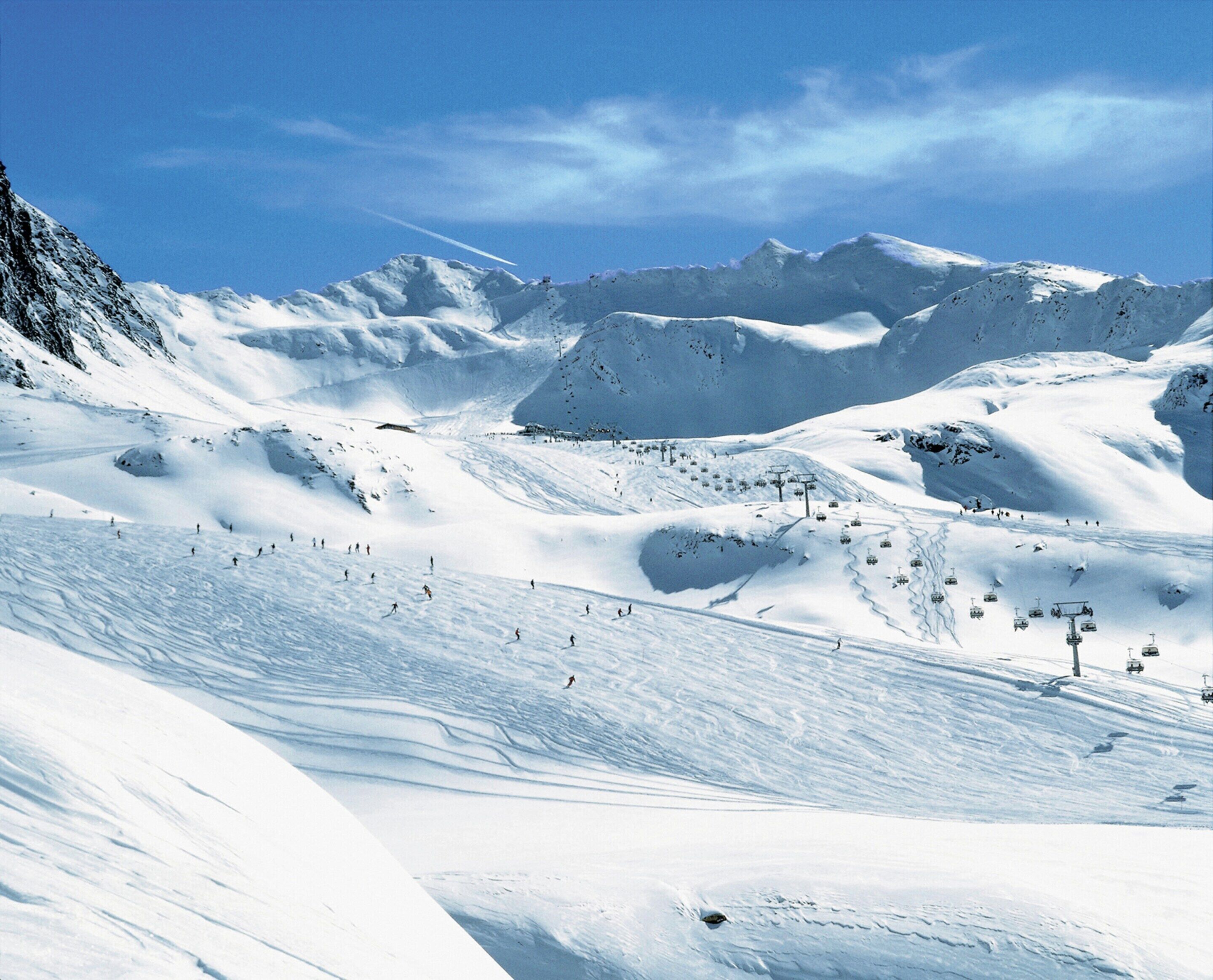 A snow-covered mountain with ski slopes and a ski lift.