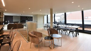 A spacious, modern interior with a dining area, seating arrangements, and a kitchen. - Luxurious Apartment in Nieuwpoort with Hot Tub (Nieuwpoort)