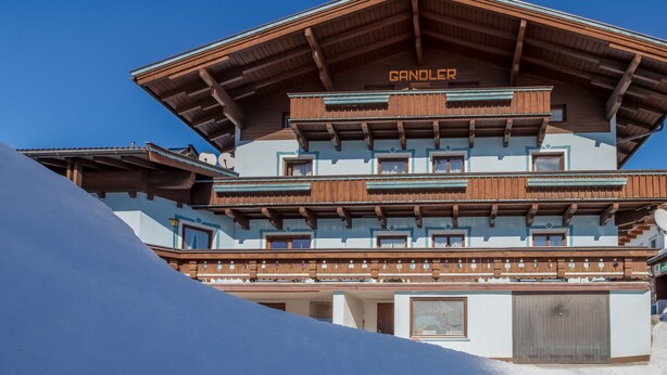 A multi-story building with a wooden facade and balconies, labeled "GANDOLER." - Spacious Apartment near Ski Area in Mittersill (Mittersill)