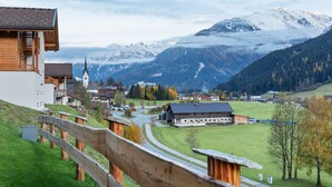 A mountainous village with traditional wooden houses, a church, and a clear view of snow-capped peaks. - Chalet in Wald Near Ski Slopes (Wald im Pinzgau)
