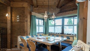 A wooden interior with a dining table, chairs, and a bench. - Spacious Apartment near Ski Area in Niedernsill (Niedernsill)