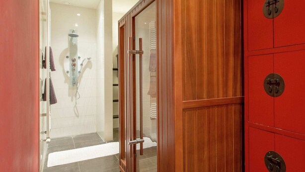 A bathroom with a shower, a wooden cabinet, and a tiled floor. - Waterfront Stelp Farmhouse With Sauna (Molkwerum)