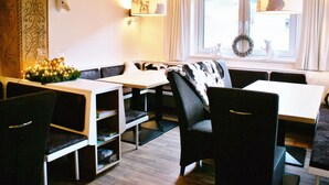 A cozy room with a wooden ceiling, a bench, a table, and chairs. - Luxury Chalet with Sauna near Ski Area in Salzburg (Saalbach-Hinterglemm)