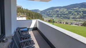 A balcony with a view of a town and mountains. - Luxurious Apartment in Fugenberg With Sauna (Fuegenberg)
