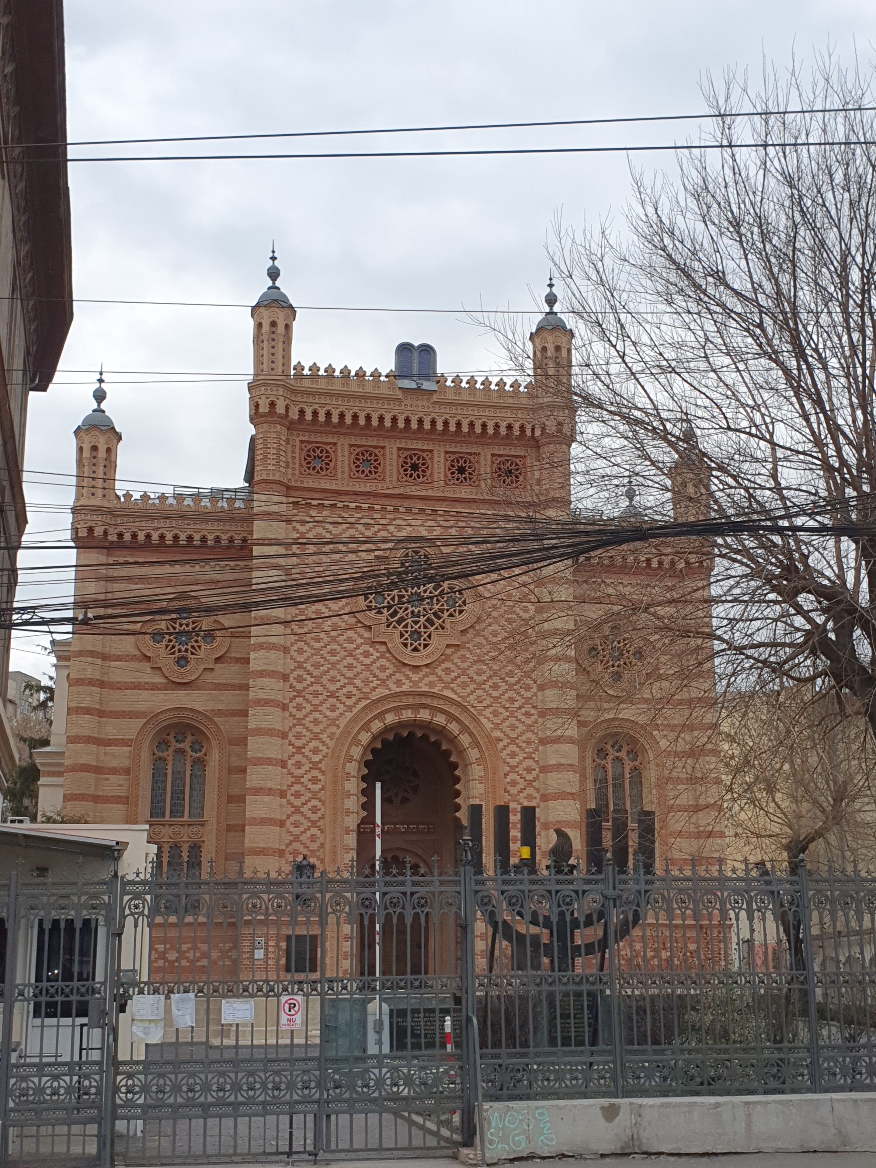A historic building with intricate architectural details, including arched windows and decorative patterns.
