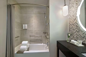 Combined shower/bathtub, designer toiletries, hair dryer, slippers