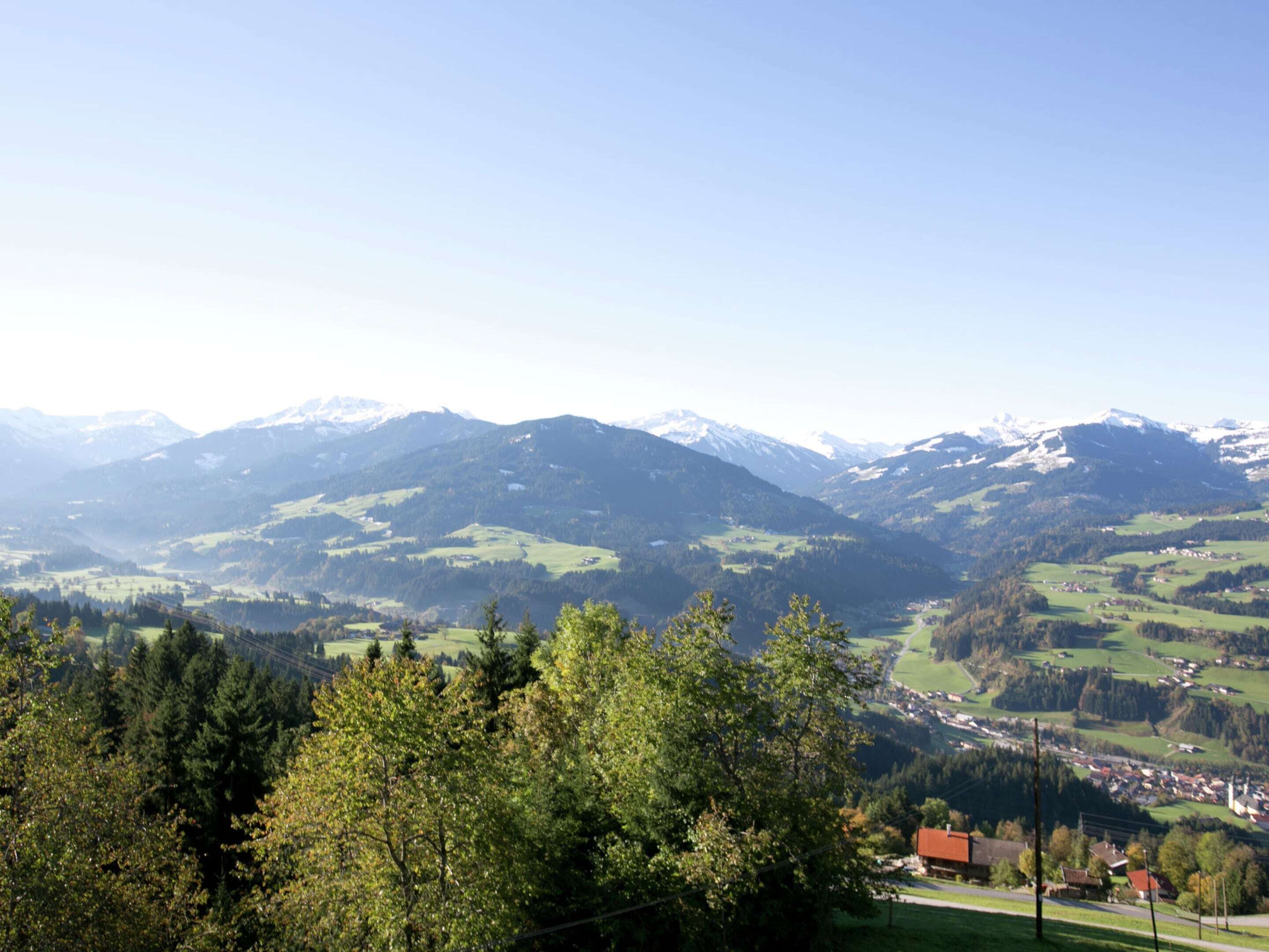 A mountainous landscape with a village nestled in the valley.