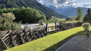 A mountainous landscape with a wooden fence, grassy areas, and a clear sky. - Premium Chalet With Sauna on a Sunny Slope (Neukirchen am Grossvenediger)