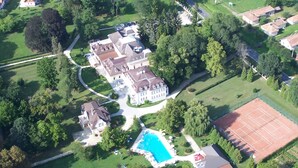 An aerial view of a large estate with multiple buildings, a tennis court, and a swimming pool. - Batthyány Kastélyszálló (Zalacsany)