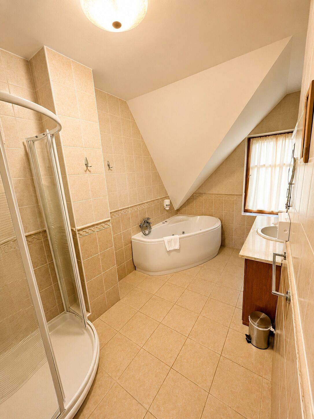 A bathroom with a shower, a bathtub, and a toilet.