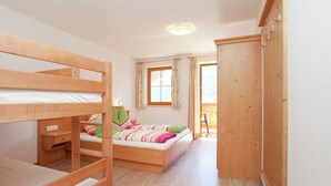 A room with a bunk bed, a desk, a chair, and a wardrobe. - Apartment in Mittersill Near Kitzbuhel Ski Area (Mittersill)