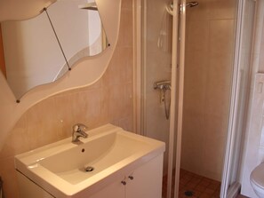 A bathroom with a sink, mirror, and shower. - Chalet in Furth Near Zell am See Ski Slopes (Piesendorf)