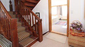 A wooden staircase with patterned carpet leading to a room. - Cozy Chalet in Bramberg am Wildkogel with Sauna near Ski Lift (Bramberg am Wildkogel)